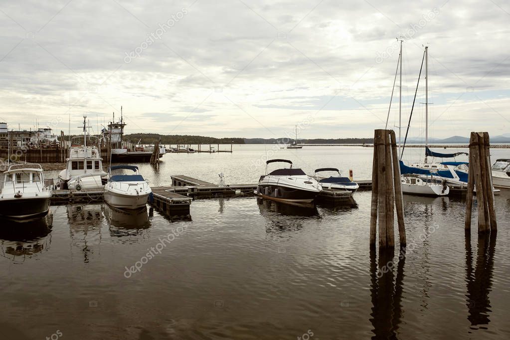 Boats and yachts moored on a marina of Lake Champlain waterfront on a Fall day in Burlington.  Vermont, USA
