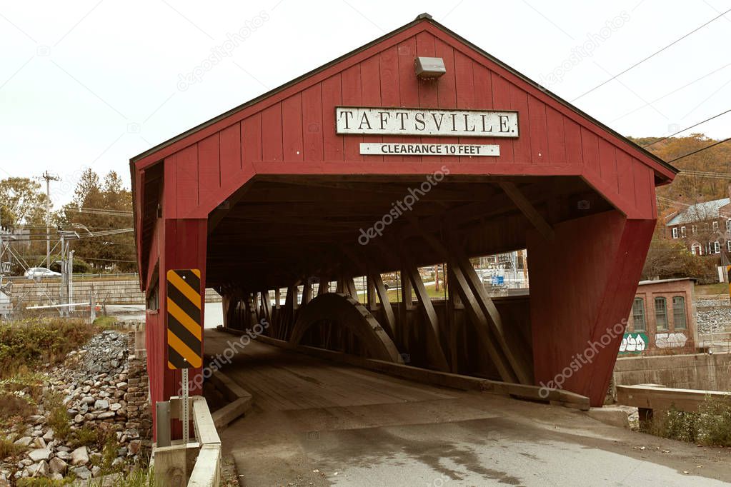Historic Taftsville Covered Bridge surrounded by Fall foliage in Woodstock, Vermont.  Vermont, USA
