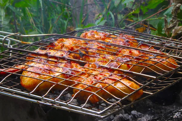 Chicken wings meat on barbecue grill grid — Stock Photo, Image