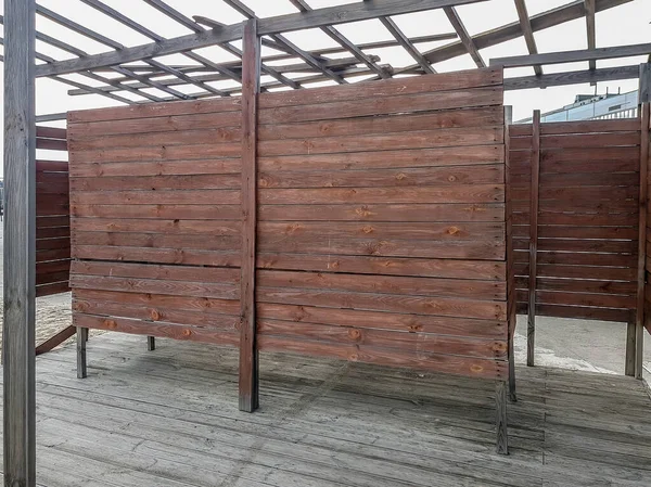 stock image Brown wooden dressing room on a sandy beach on a sunny day