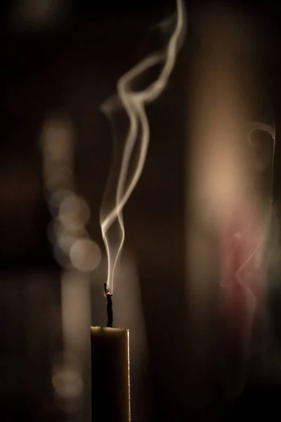 Fumée grise volant à l'envers des bougies jaunes éteintes — Photo