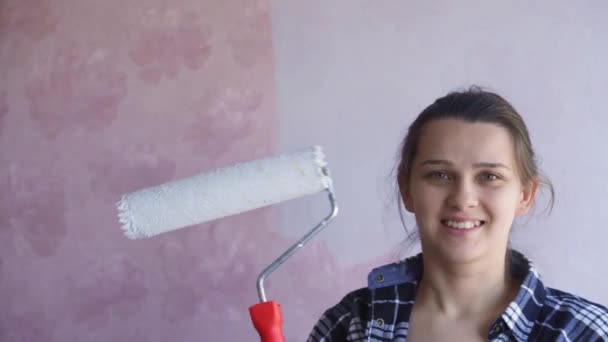 Beautiful Couple Decorate Their New Apartment and Fool Around. Husband and Wife are Painting the Wall with Rollers that are Dipped in Light Blue Paint. They are Happy and Have Fun. Renovations at Home — Stock Video