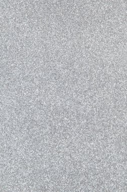 Gümüş renkli ışıl ışıl bir arka plan, yakın plan. Uzayı metin için kopyala. Dikey. Kutlamalar, tatiller, satışlar, moda konsepti, maket için hasat