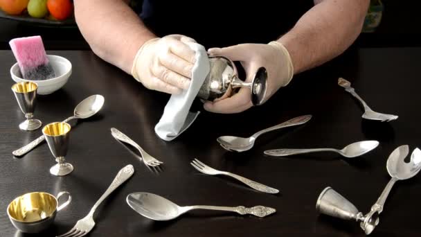 Man hands polishing silver cup with cloth — Stock Video