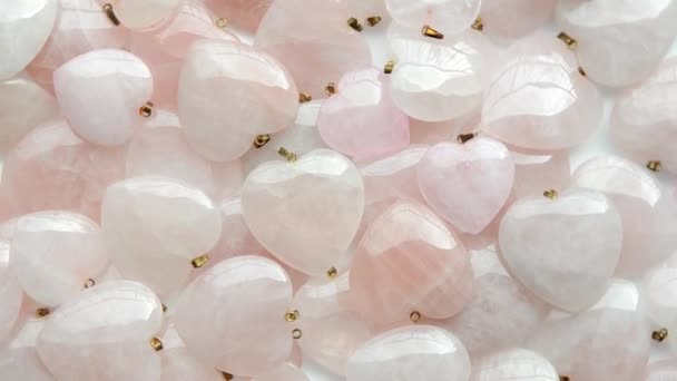 Small ring-shaped rose quartz hearts turn around — Stock Video