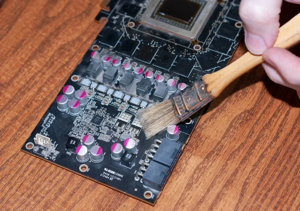 Cropped View Repairman Cleaning Disassembled Graphics Card Brush Wooden Table — Stock Photo, Image