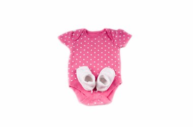 baby expectation concept with baby socks on pink bodysuit for newborn with polka dot isolated on white