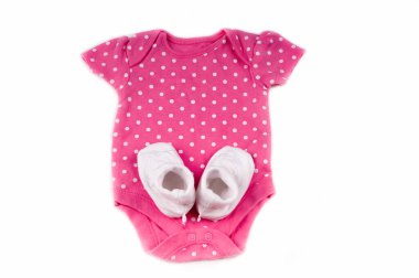 baby expectation concept with pink baby bodysuit with polka dot and socks isolated on white