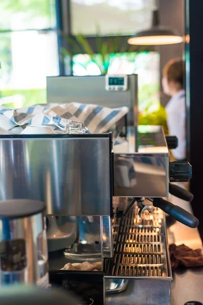 Professional coffee machine making latte art in a cafe