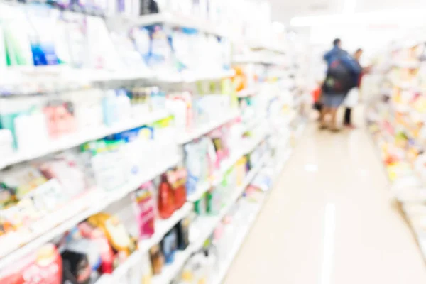 Shelf blurred of modern supermarket with people light