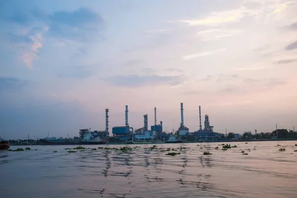 Oil refinery construction plant sunrise with river, Energy industry