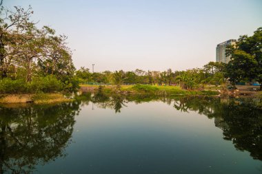 Yeşil çim günbatımı sırasında bina ile Park