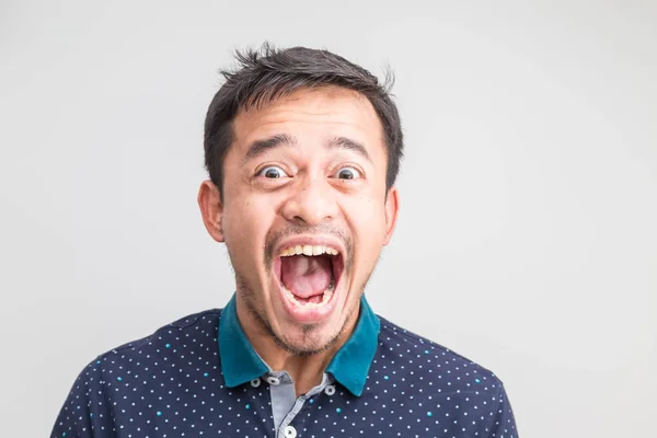 Portrait of extremely angry asian man face on white background