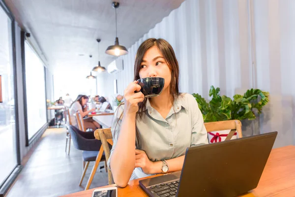 Attractive business women use laptop with latte coffee drink,  Freelance business