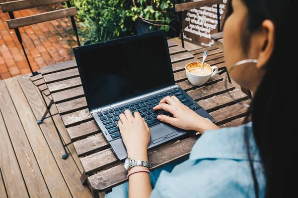 Femeie care lucrează pe laptop în cafeneaua modernă în aer liber — Fotografie, imagine de stoc