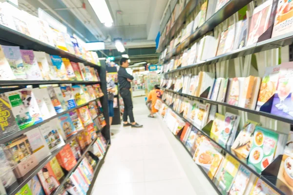 Blurred background of people read book at bookshelves in book st — Stock Photo, Image