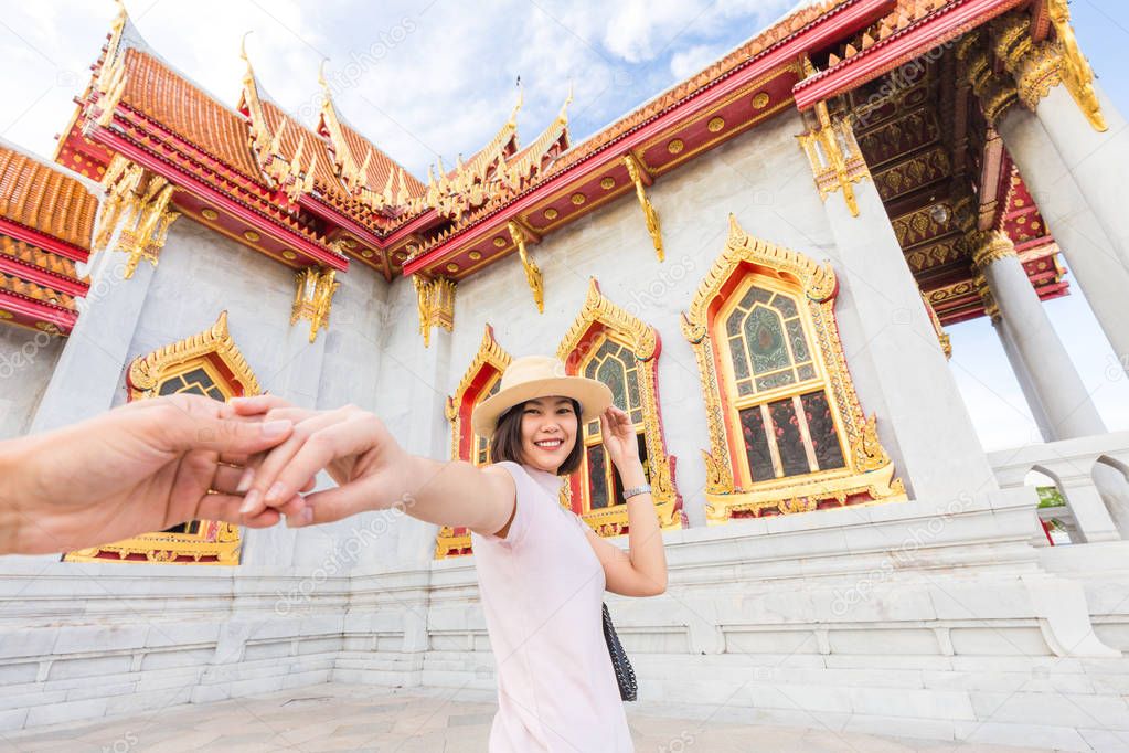 Asian tourist women travel welcome in marble temple at Bangkok Thailand