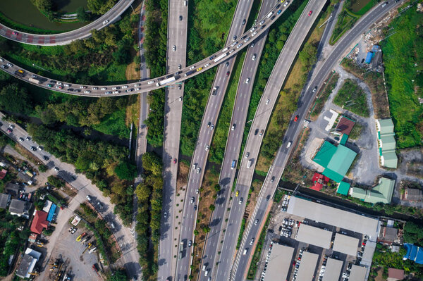 Aerial view of traffic intersection city road look down with green tree