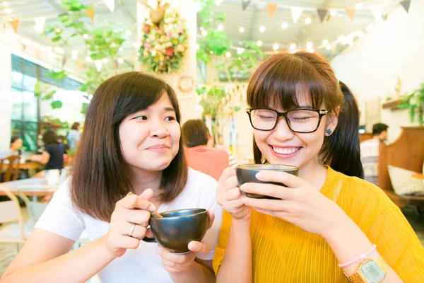 Drinking with friend of two smiling women laughing while gossip — Stock Photo, Image