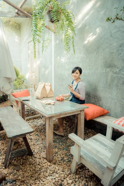 Asian women drinking coffee in art cafe