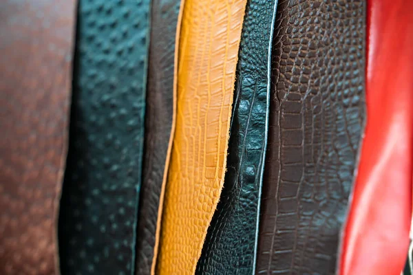 Raw genuine cowhide leather on shelf in craft shop DIY store