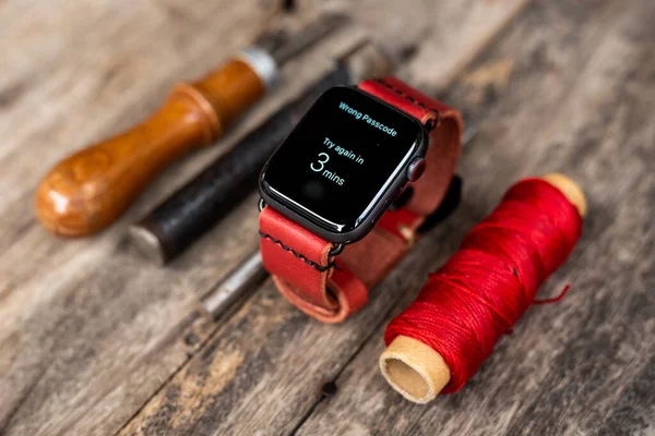 Craft working of leather watch strap on wood table