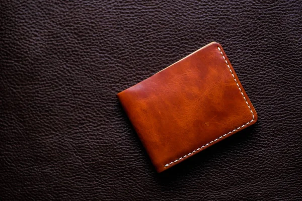 Genuine leather wallet handmade on leather background craftsmanship object