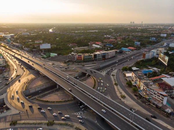 Aerial top view circular junction city transport road with car movement sunset