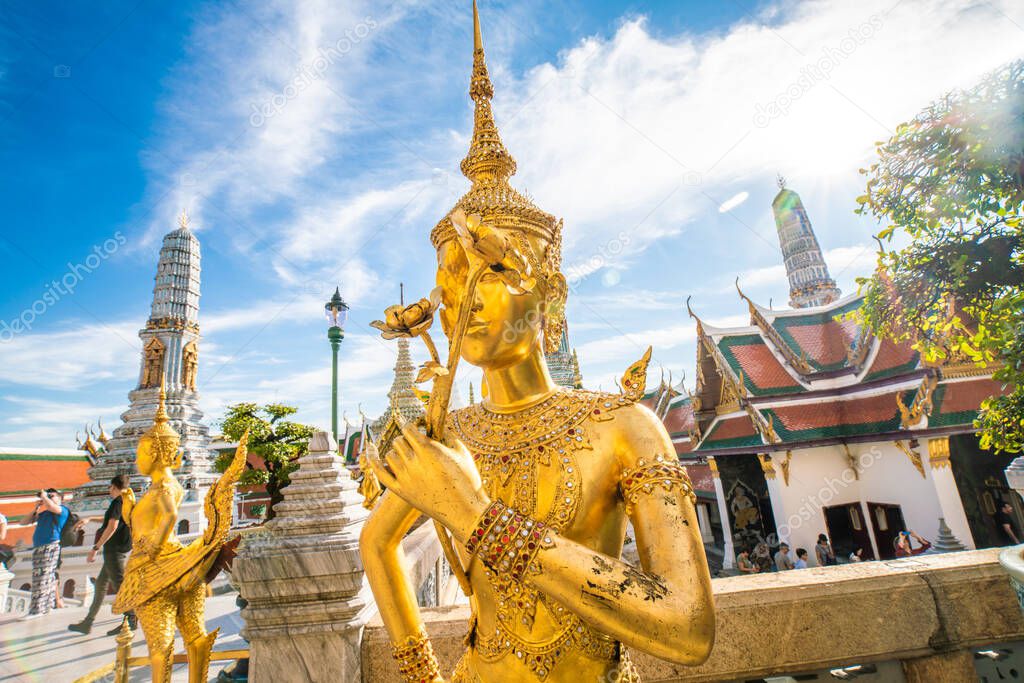 Emerald buddha temple golden pagoda blue sky with cloud sightseeing in Bangkok, Thailand