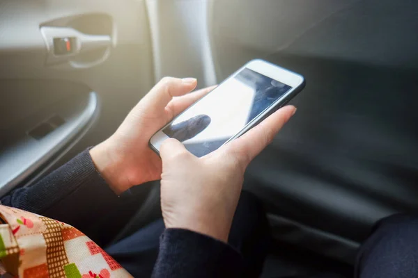 Hand using smartphone in taxi car blank screen transport business