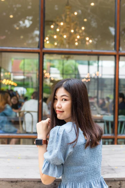 Smiling entrepreneur women sitting in coffee shop thinking business idea