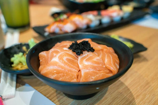 Salmon sashimi on top of japanese rice with fish egg, Japanese food