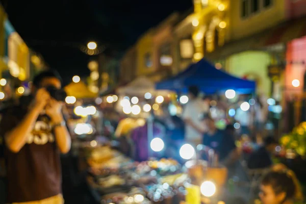 Abstract night blurred people shopping on street market with bokeh, Phuket market