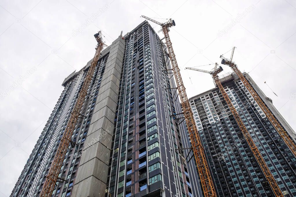 Construction site modern high rise condominium building in growth business city
