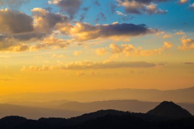 Dağ manzarası günbatımı siluet doğa sahnesi bulutlu renkli gökyüzü