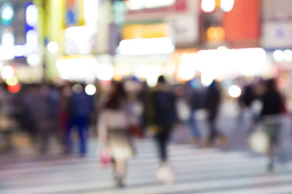 Blurred night traffic movement and people walking in Shibuya Tokyo town, Japan