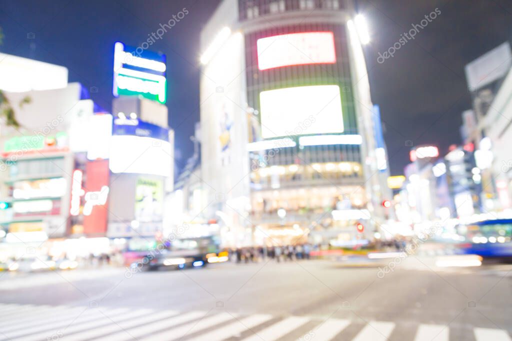 Blurred night traffic movement and people walking in Shibuya Tokyo town, Japan