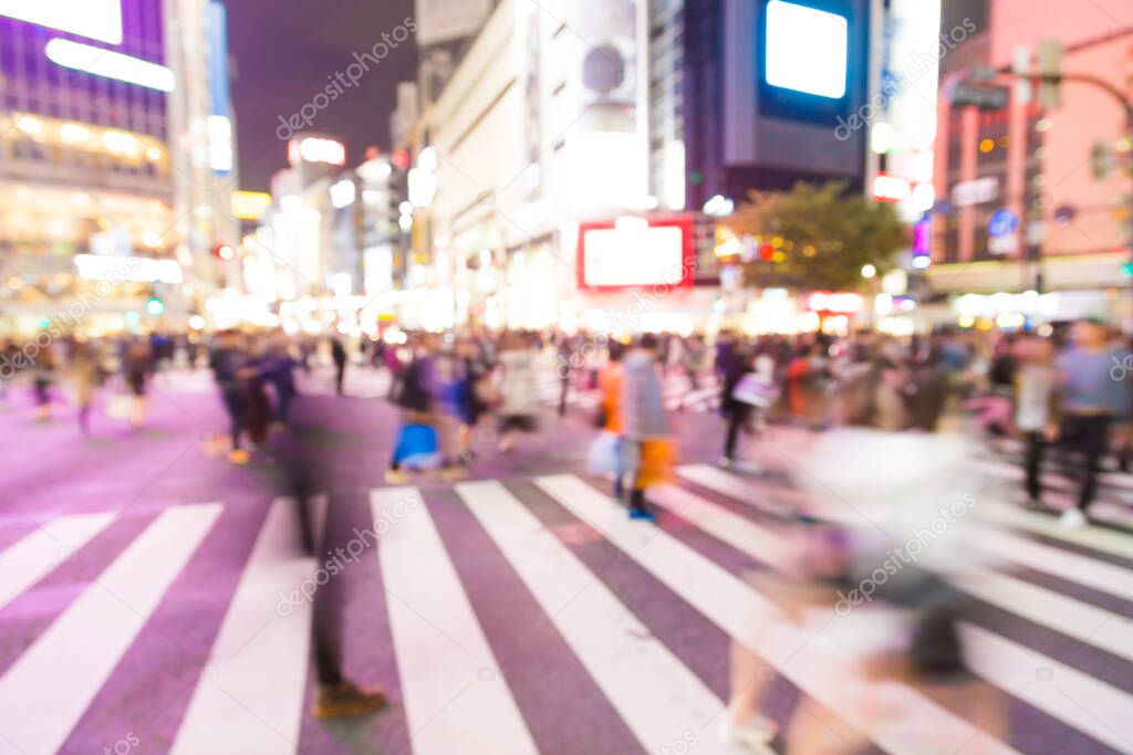 Blurred night traffic movement and people walking in Shibuya Tokyo town, Japan