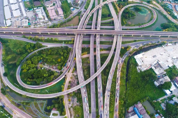 Aerial view of city transport junction road with vehicle and green tree