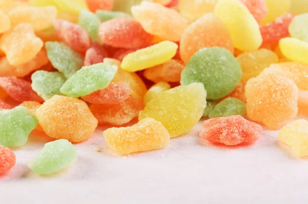 Many multicolored candies on a pink background horizontal — Stock Photo, Image