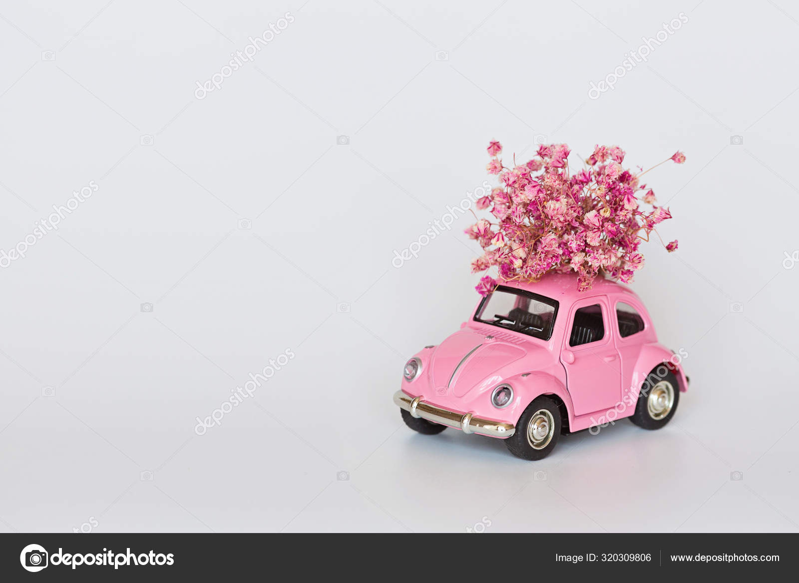 Changxing, China October 15, 2019: Pink retro toy car delivering