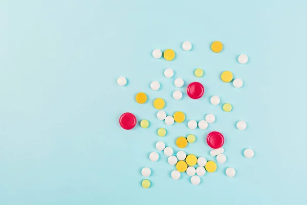 Colorful pills on a pastel blue background. Flat lay, top view, overhead, mockup, template. Pharmacy and medical concept — Stock Photo, Image