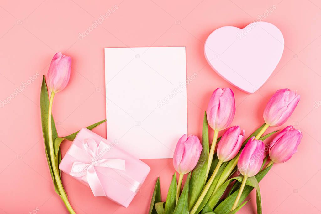 View from above tulips and gift box with copy space. Background for womens day, 8 March Valentines day, 14 february. Flat lay style, top view, mockup, template, overhead. Greeting card