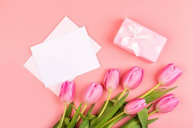 Yukarıdan laleleri ve fotokopi alanı olan hediye kutusunu izle. Kadınlar Günü için arka plan, 8 Mart Sevgililer Günü, 14 Şubat. Düz yatış stili, üst görünüm, model, şablon, genel giderler. Tebrik kartı