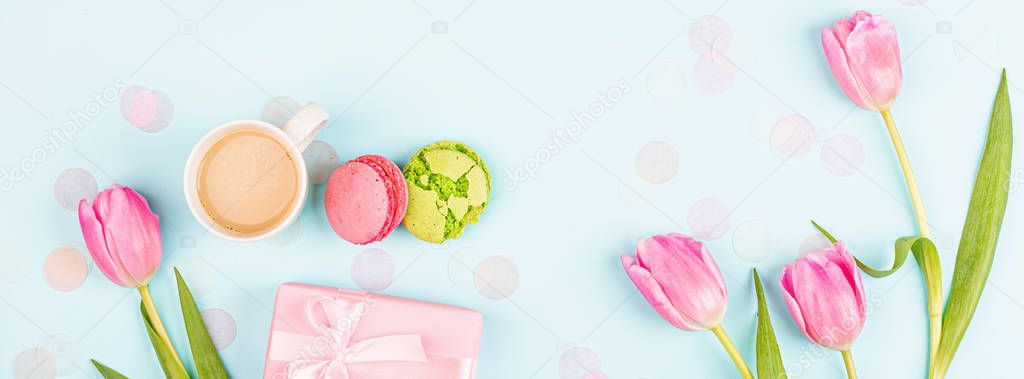 View from above tulips and gift box on blue. Background for womens day, 8 March Valentine's day, 14 february. Flat lay style, top view, mockup, template, overhead. Greeting card