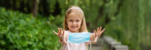 Happy Little Girl Takes Protective Medical Mask Face Outdoors Victory — Stock Photo, Image