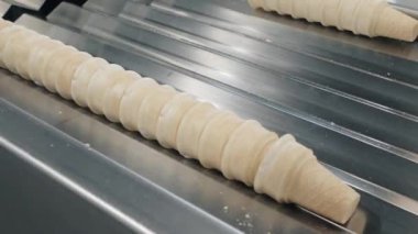employee takes waffle cups stack for packaging closeup