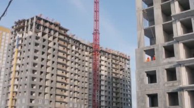 lattice crane tower between houses built of panel blocks