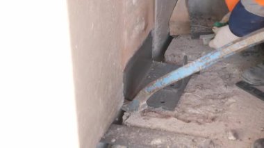builder installs mount to wall panel and colleague helps
