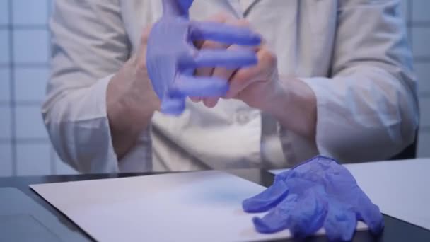 Scientist puts on gloves in coronavirus researching lab — Stock Video